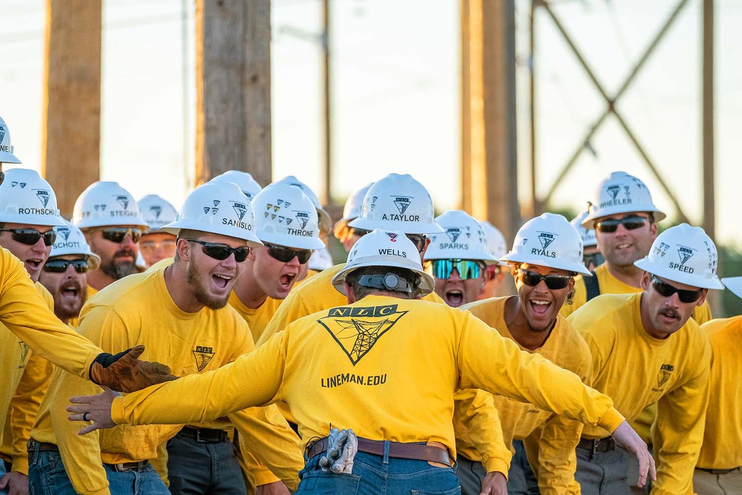 NLC students in yellow shirts, hyped up at lineman rodeo